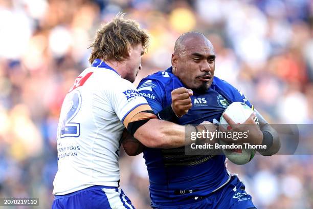 Junior Paulo of the Eels is tackled by Jacob Preston of the Bulldogs during the round one NRL match between Parramatta Eels and Canterbury Bulldogs...