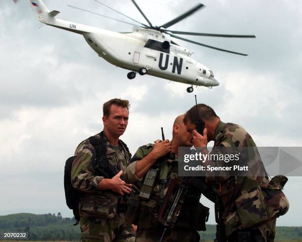 French troops stand guard as a United Nations helicopter takes off June 10, 2003 in Bunia, the provincial capital of Ituri province in the Democratic...