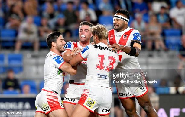 Kyle Flanagan of the Dragons celebrates with team mates after scoring a try during the round one NRL match between the Gold Coast Titans and St...