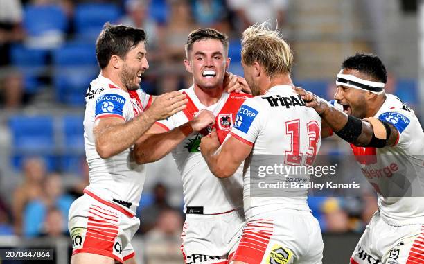 Kyle Flanagan of the Dragons celebrates with team mates after scoring a try during the round one NRL match between the Gold Coast Titans and St...