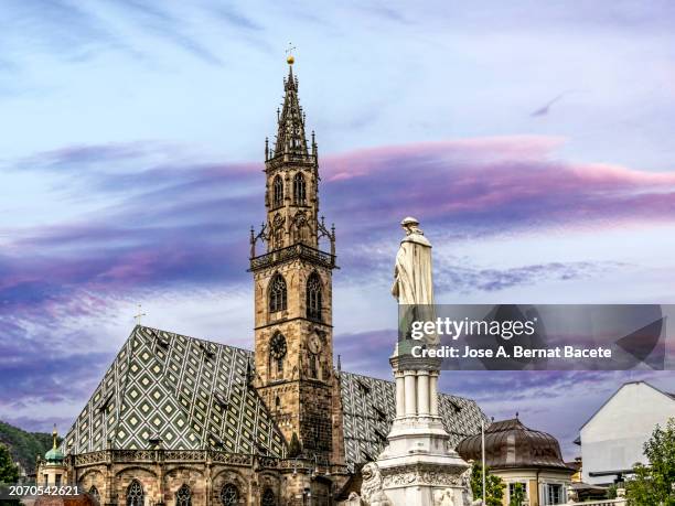 bolzano city church at sunset in the dolomite alps, italy. - bolzano stock pictures, royalty-free photos & images