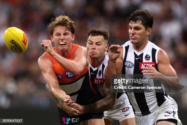 Lachie Whitfield of the Giants handpasses the ball during the AFL Opening Round match between Greater Western Sydney Giants and Collingwood Magpies...