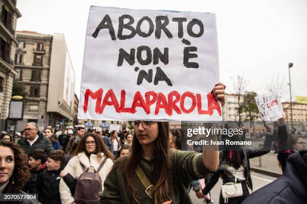 Girl holds up a banner that reads: "Aborto non è 'na malaparola" during a march for International Women's Day on March 08, 2024 in Naples, Italy. On...