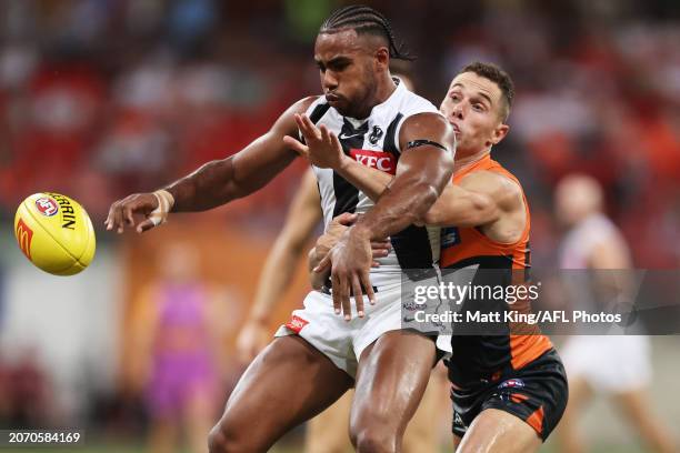 Isaac Quaynor of the Magpies is challenged by Josh Kelly of the Giants during the AFL Opening Round match between Greater Western Sydney Giants and...