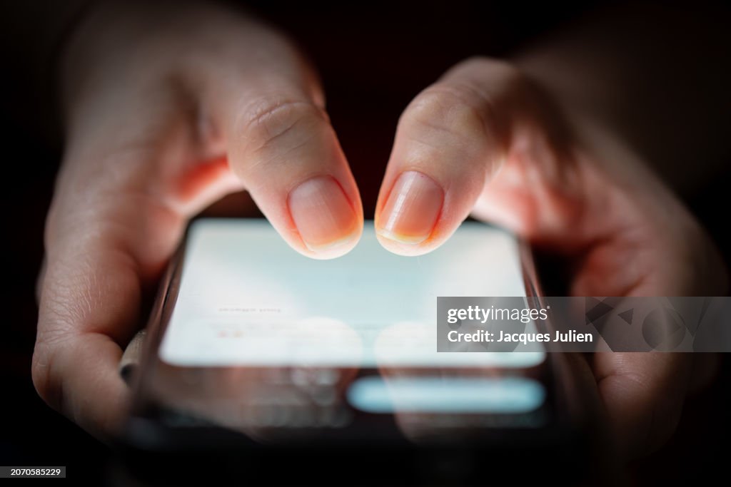 Fingers tapping smartphone screen