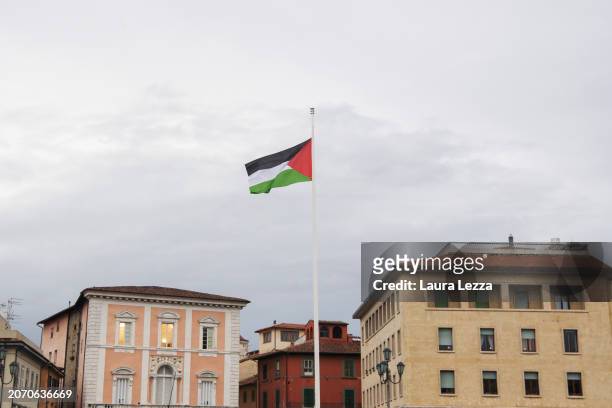 Palestinian flag hoisted on the bridge Ponte di Mezzo after women take part in a protest during the International Women's Day March organised by the...