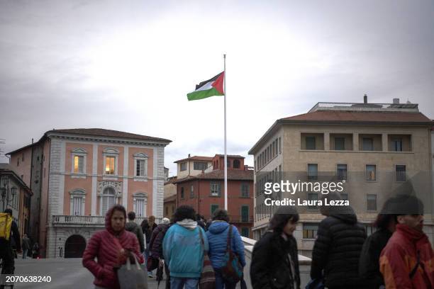 Palestinian flag hoisted on the bridge Ponte di Mezzo after women take part in a protest during the International Women's Day March organised by the...