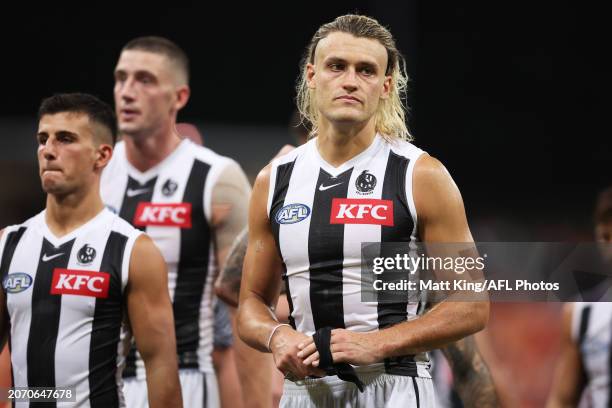 Darcy Moore of the Magpies and team mates look dejected after the AFL Opening Round match between Greater Western Sydney Giants and Collingwood...