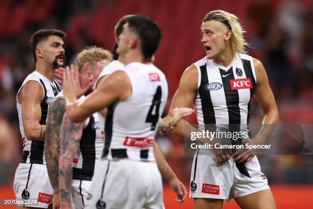 Darcy Moore of the Magpies talks to team mates as they walk off the field after losing the AFL Opening Round match between Greater Western Sydney...