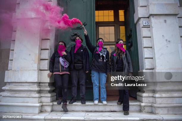 Women take part in a protest with a smoke bomb during the International Women's Day March organised by the Italian movement 'Non una di meno' on...