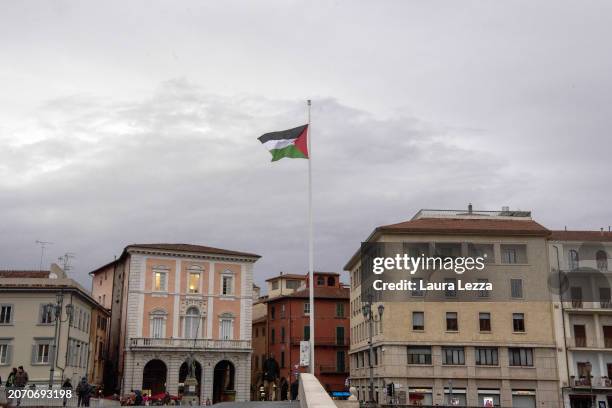 Palestinian flag hoisted on the bridge Ponte di Mezzo after women take part in a protest during the International Women's Day March organised by the...