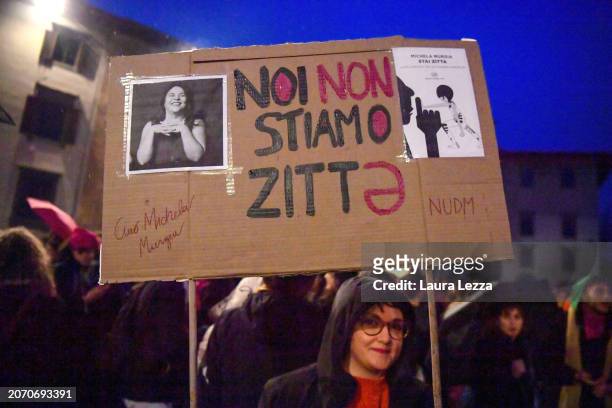 Woman takes part in a protest with a sign paying homage to the dead writer Michela Murgia and the writing with the schwa: 'We are not silent' during...
