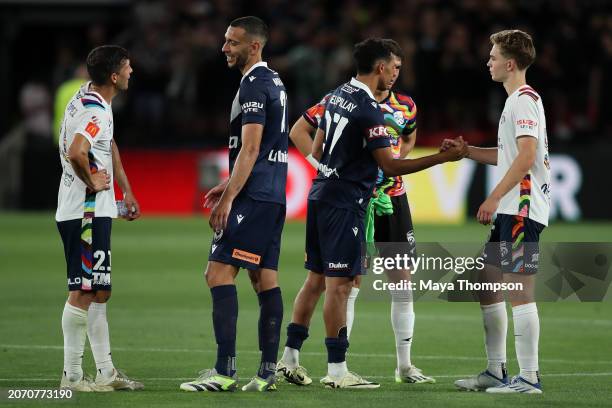Javi Lopez, Ethan Cox, and Ethan Alagich of Adelaide United congratulate Roderick Miranda and Nishan Velupillay of Melbourne Victory after the...
