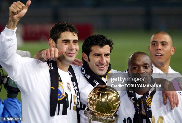 Real Madrid star players Fernando Hierro, gives thumbs-up, with Luis Figo, Claude Makelele and Ronaldo celebrate their winning of the Europe/South...