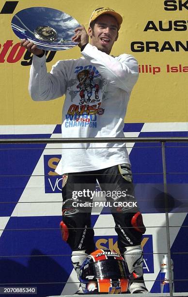 Marco Melandri of Italy holds up his trophy after winning the 250cc Motocycle Grand Prix world title in Phillip Island, 20 October 2002. Melandri won...
