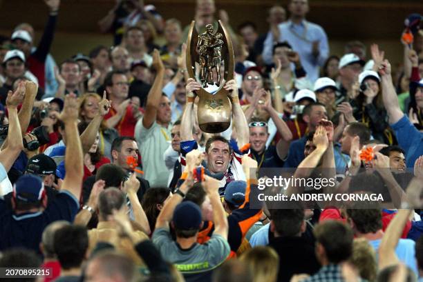 Sydney City Rooster and captain Brad Fittler holds aloft the Telstra Cup and celebrates winning the NRL Grand Final by defeating the New Zealand...