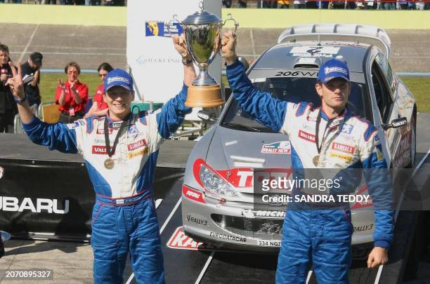 Marcus Gronholm and co-driver Timo Rautiainen of Finland hold the cup aloft after winning the Rally of New Zealand at the Manukau Veladrome, 06...