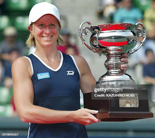 American Jill Craybas holds winners trophy during an award ceremony for the women's singles final against Silvija Talaja of Croatia at the Japan Open...