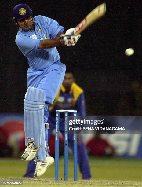 Indian batsman Virender Sehwag pulls a ball as Sri Lankan fielder Russal Arnold looks on during the ICC Champions Trophy final match between India...