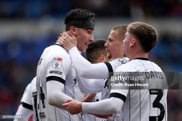 Kieffer Moore of Ipswich Town celebrates scoring his team's first goal with teammates Harry Clarke and Leif Davis during the Sky Bet Championship...