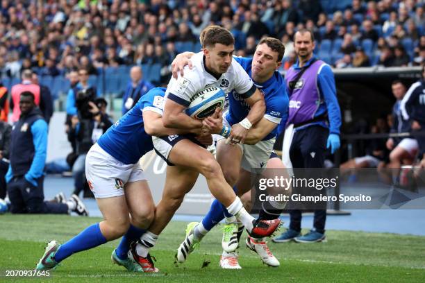 Cameron Redpath of Scotland is tackled by Louis Lynagh and Paolo Garbisi of Italy during the Guinness Six Nations 2024 match between Italy and...