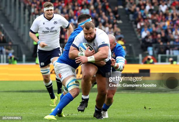 Pierre Schoeman of Scotland is tackled by Sebastien Negri and Simone Ferrari of Italy during the Guinness Six Nations 2024 match between Italy and...