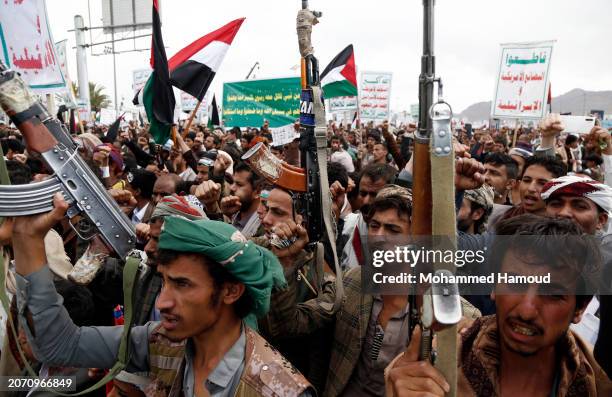 Yemen's Houthi followers lift weapons, flags of Yemen and Palestine, placards depicting the Houthi leader Abdul Malik Al-Houthi, Houthi anti-USA and...