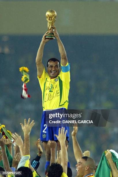 Brazil's team captain and defender Cafu hoists the World Cup trophy during the award ceremony at the International Stadium Yokohama, Japan, 30 June,...