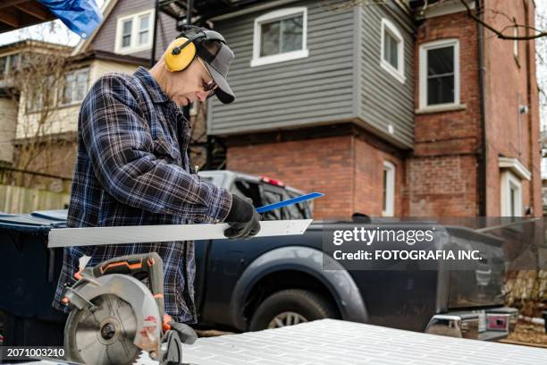 senior male hobby carpenter working outdoors - circular saw stock pictures, royalty-free photos & images