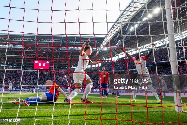 Castello Lukeba and Willi Orban of RB Leipzig celebrate after Thomas Isherwood of SV Darmstadt 98 scores a own goal during the Bundesliga match...