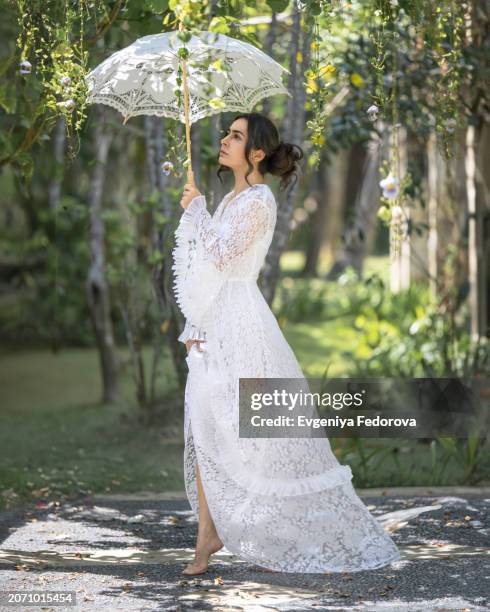 girl under a lace umbrella in the garden - bali women tradition head stock pictures, royalty-free photos & images