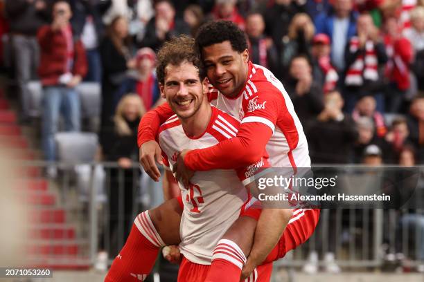 Serge Gnabry of Bayern Munich celebrates scoring his team's sixth goal with teammate Leon Goretzka during the Bundesliga match between FC Bayern...