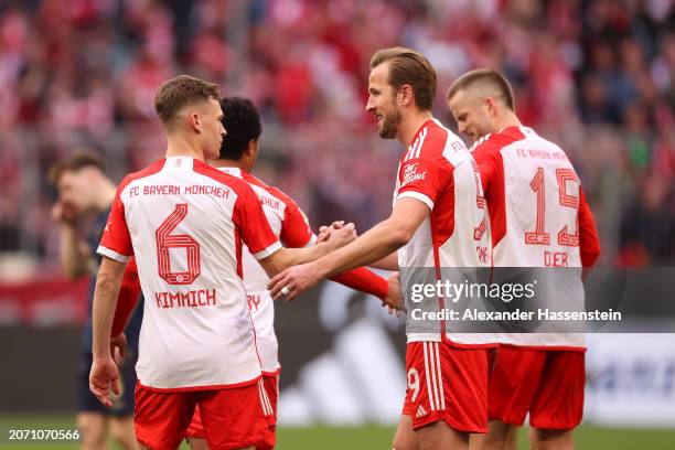 Harry Kane of Bayern Munich celebrates scoring his team's seventh goal and his hat-trick goal with teammate Joshua Kimmich during the Bundesliga...