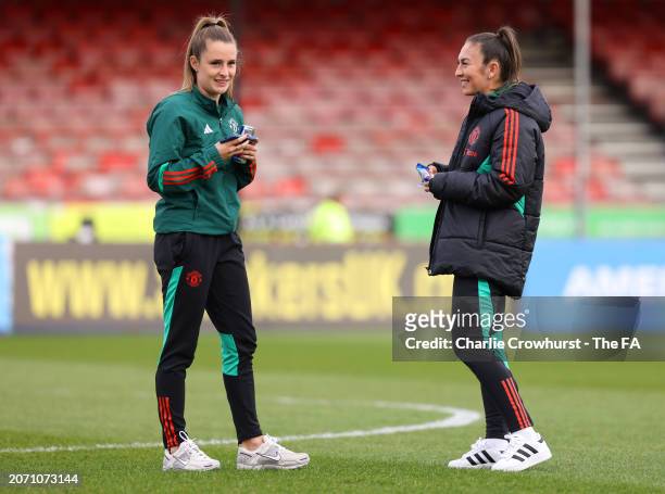 Ella Toone and Katie Zelem of Manchester United United look on during a pitch inspection ptthe Adobe Women's FA Cup Quarter Final match between...