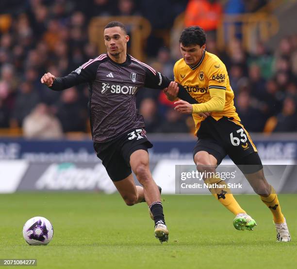 Antonee Robinson of Fulham is challenged by Nathan Fraser of Wolverhampton Wanderers during the Premier League match between Wolverhampton Wanderers...