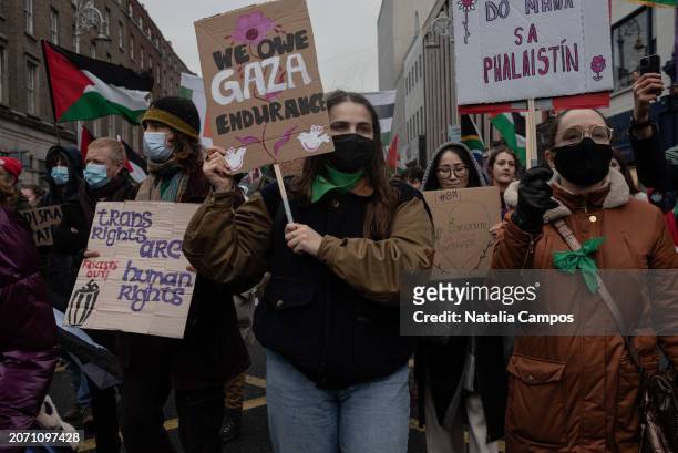 Demonstrators march holding placards on March 9, 2024 in Dublin, Ireland. Today's march is organised by the Rosa Socialist Feminist Group and...