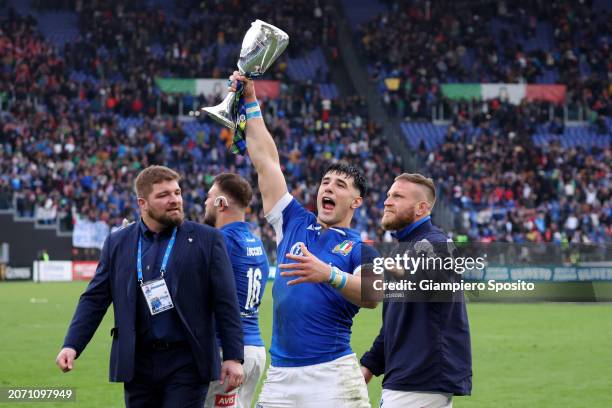 Tommaso Menencello of Italy celebrates with the Cuttitta Cup following the team's victory during the Guinness Six Nations 2024 match between Italy...