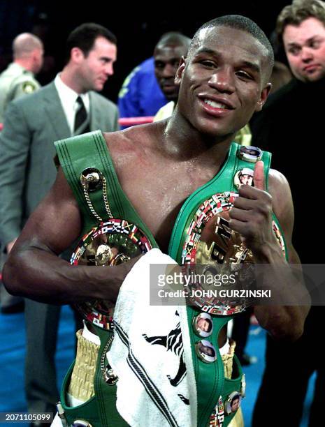 Floyd Mayweather of Grand Rapids, MI poses as he holds the WBC Lightweight Championship belt after beating Jose Luis Castillo of Sonora, Mexico in a...