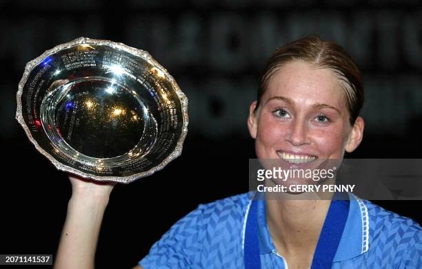 Camilla Martin of Denmark proudly holds her trophy after beating Gong Ruina of China 10 March 2002, in the All England Open Women's Badminton Singles...