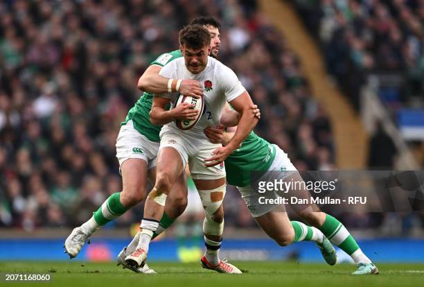 George Furbank of England is tackled by Robbie Henshaw and Ciaran Frawley of Ireland during the Guinness Six Nations 2024 match between England and...