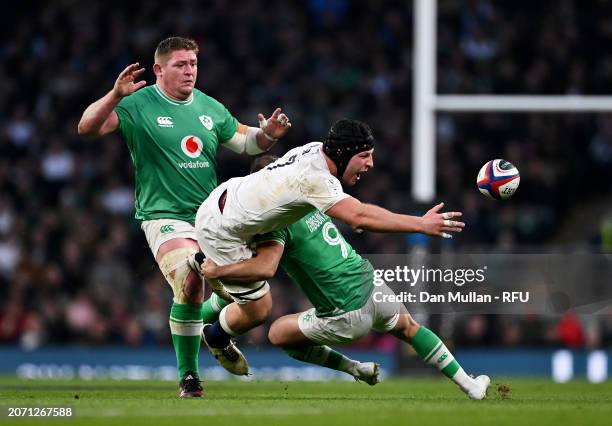 Sam Underhill of England offloads as he is tackled by Jamison Gibson-Park of Ireland during the Guinness Six Nations 2024 match between England and...