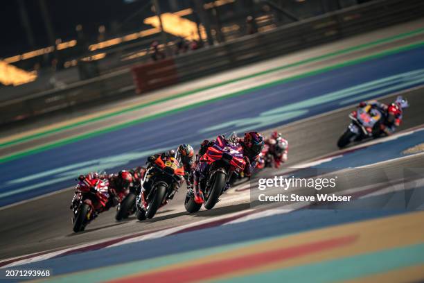 Jorge Martin of Spain and Prima Pramac Racing leads the Race in front of Brad Binder of South Africa and Red Bull KTM Factory Racing and Francesco...