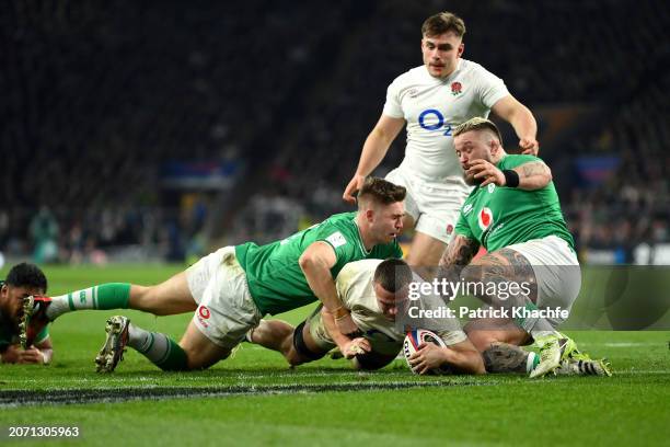 Ben Earl of England scores his team's third try despite the challenge of Jack Crowley of Ireland during the Guinness Six Nations 2024 match between...