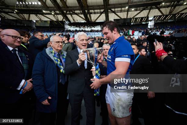 Michele Lamaro of Italy receives the Cuttitta Cup from FIR president Marzio Innocenti during the Guinness Six Nations 2024 match between Italy and...