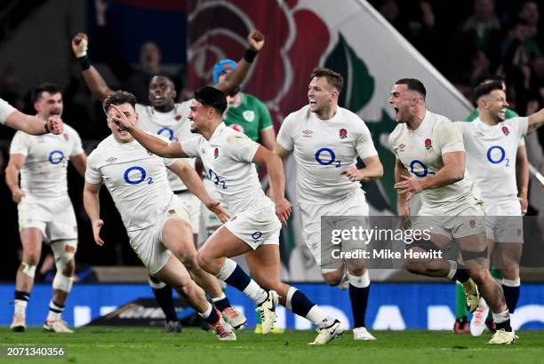 Marcus Smith of England celebrates scoring the winning drop goal as teammates celebrate behind during the Guinness Six Nations 2024 match between...