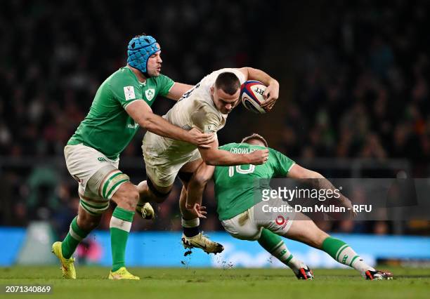 Ben Earl of England is tackled by Jack Crowley and Tadhg Beirne of Ireland during the Guinness Six Nations 2024 match between England and Ireland at...