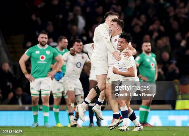 Marcus Smith of England celebrates scoring the winning drop goal with teammates during the Guinness Six Nations 2024 match between England and...