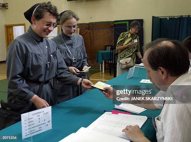Two nuns from the Urszulanki convent, the place from which Karol Wojtyla left for the conclave to Rome to become Pope, are checking their names on...