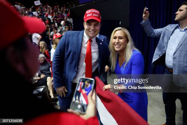 Rep. Marjorie Taylor Greene poses for photographs with supporters ahead of a campaign rally with Republican presidential candidate and former U.S....