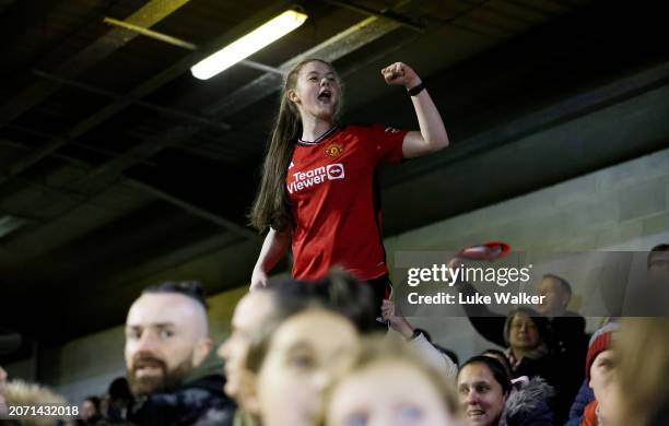 Manchester United fan celebrates in the stands following the team's victory in the Adobe Women's FA Cup Quarter Final match between Brighton & Hove...